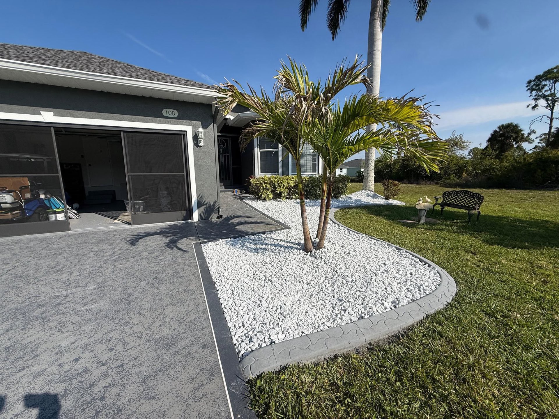 Decorative driveway curbing with palm