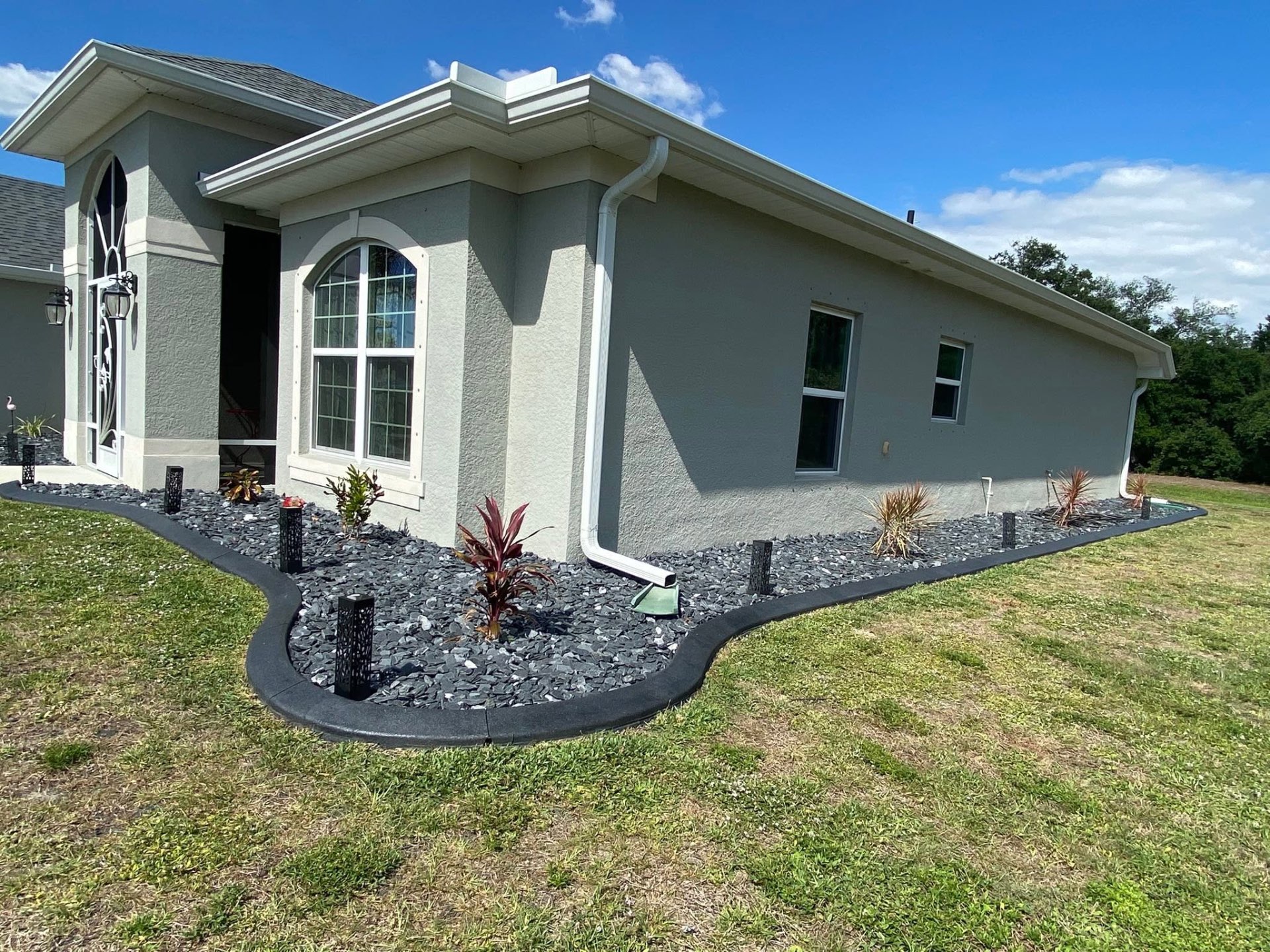 Black slate curbing around a palm island